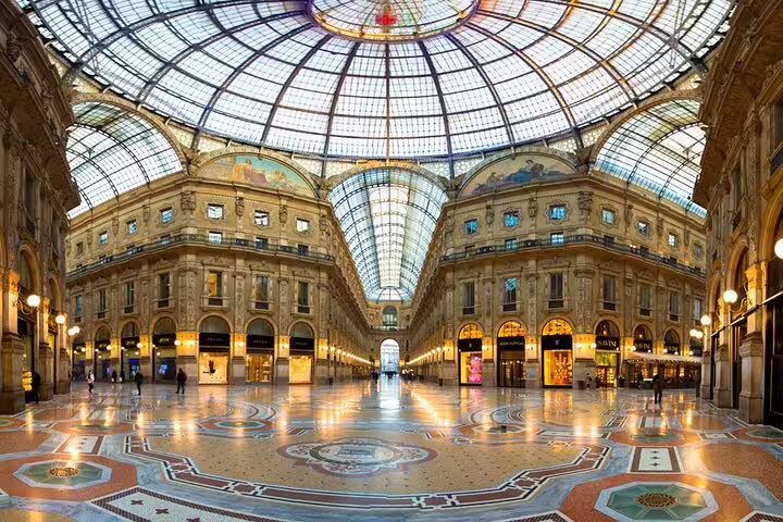 Stunning interior of Galleria Vittorio Emanuele II in Milan, highlighting its iconic glass dome and luxurious shops.
