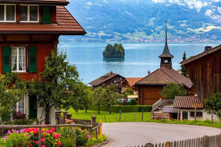 Scenic view of Interlaken's serene lake and charming village, ideal for private transfers from Milan to Interlaken.