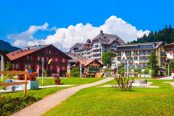 Charming Swiss village with colorful traditional houses surrounded by lush greenery en route from Milan to Interlaken.