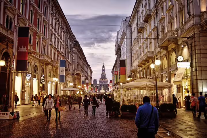 Evening stroll on Via Dante toward Castello Sforzesco, ideal for a self-guided Milan scavenger hunt