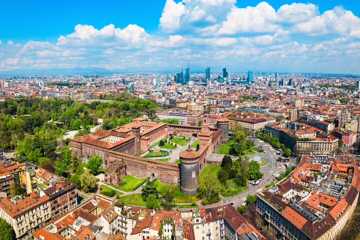 Aerial view of Sforza Castle surrounded by Milan cityscape with modern skyscrapers in background