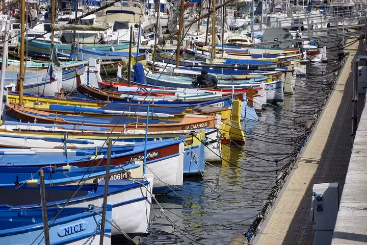 Colorful boats docked in Nice marina, highlighting coastal charm on a private Milan to Nice transfer.