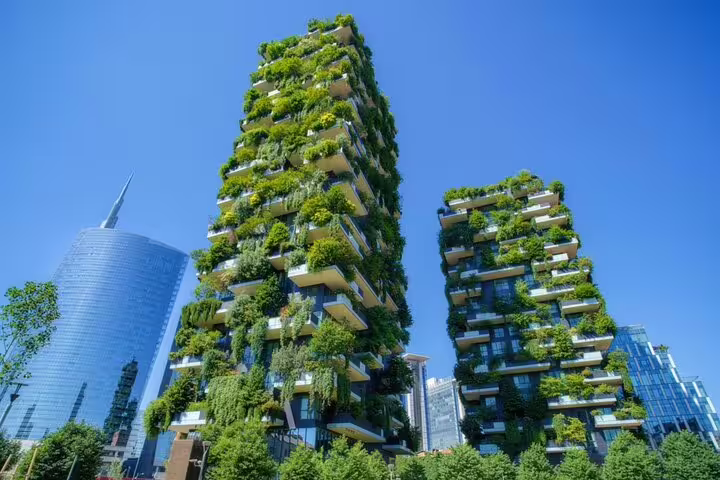 Bosco Verticale green towers covered in lush plants and trees in Milan city skyline