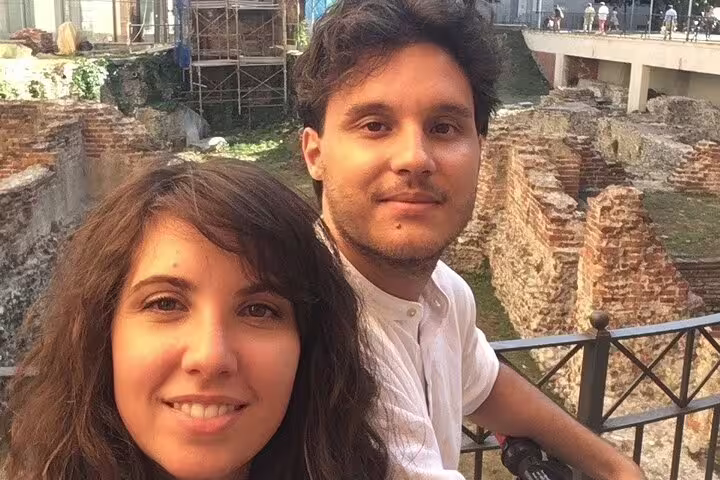 Couple taking a selfie at ancient Roman ruins during a self-guided walking tour in Milan