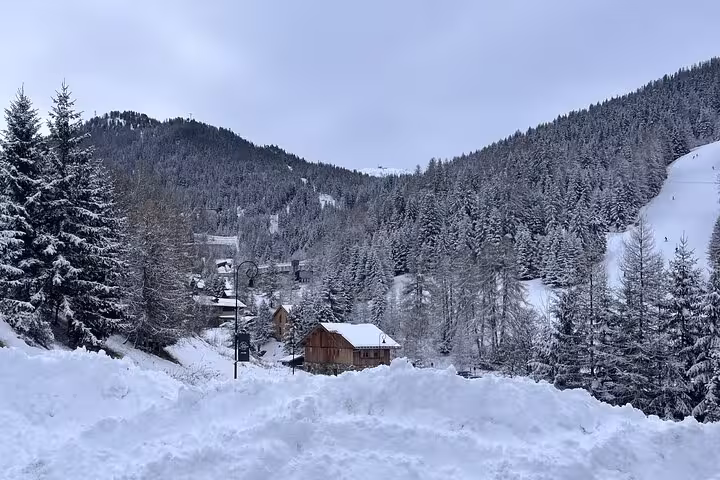 Scenic snowy mountain village view on the private transfer route from Milan to Zermatt Tasch.
