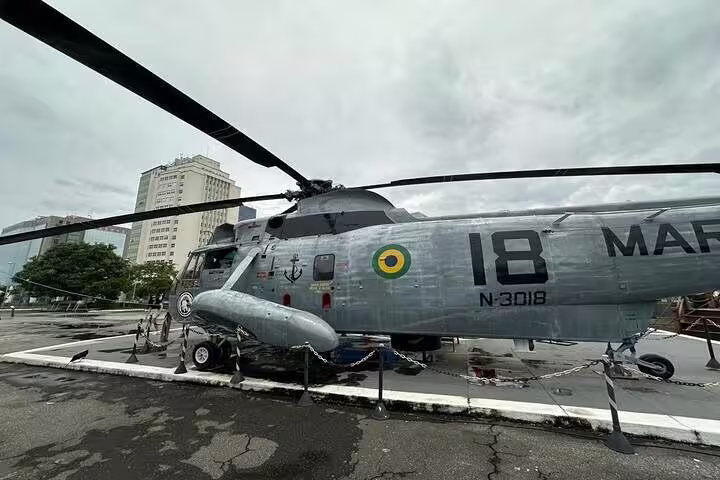 Military helicopter displayed at Fiscal Island near Guanabara Bay, part of Brazil Imperial Rio boat tour.