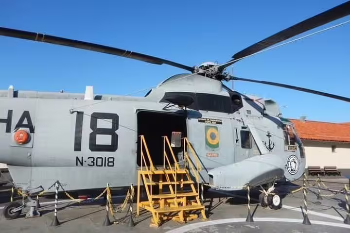 Military helicopter on display during the Brazil Imperial boat tour, showcasing Rio's naval history at Fiscal Island.