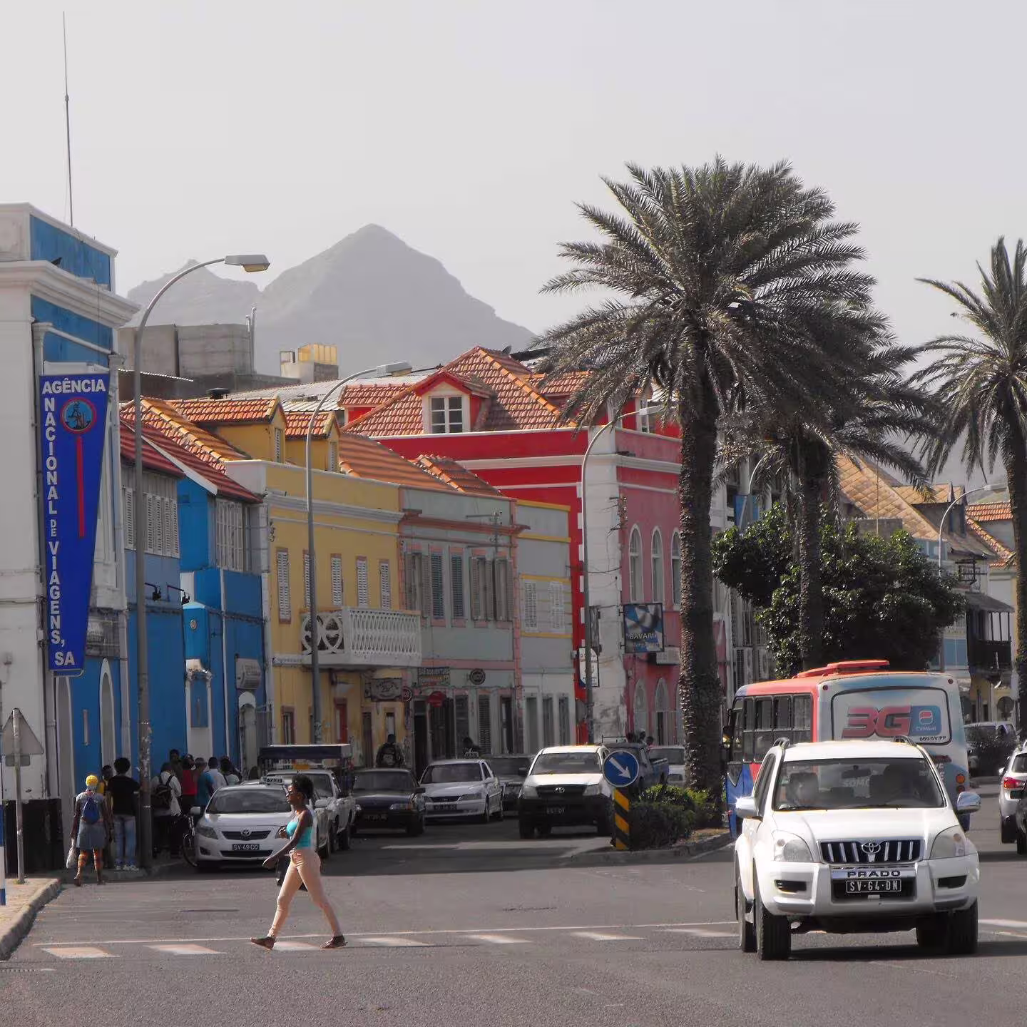 Vibrant streets of Mindelo with colorful colonial buildings and palm trees, ideal for exploring on a city walking tour.