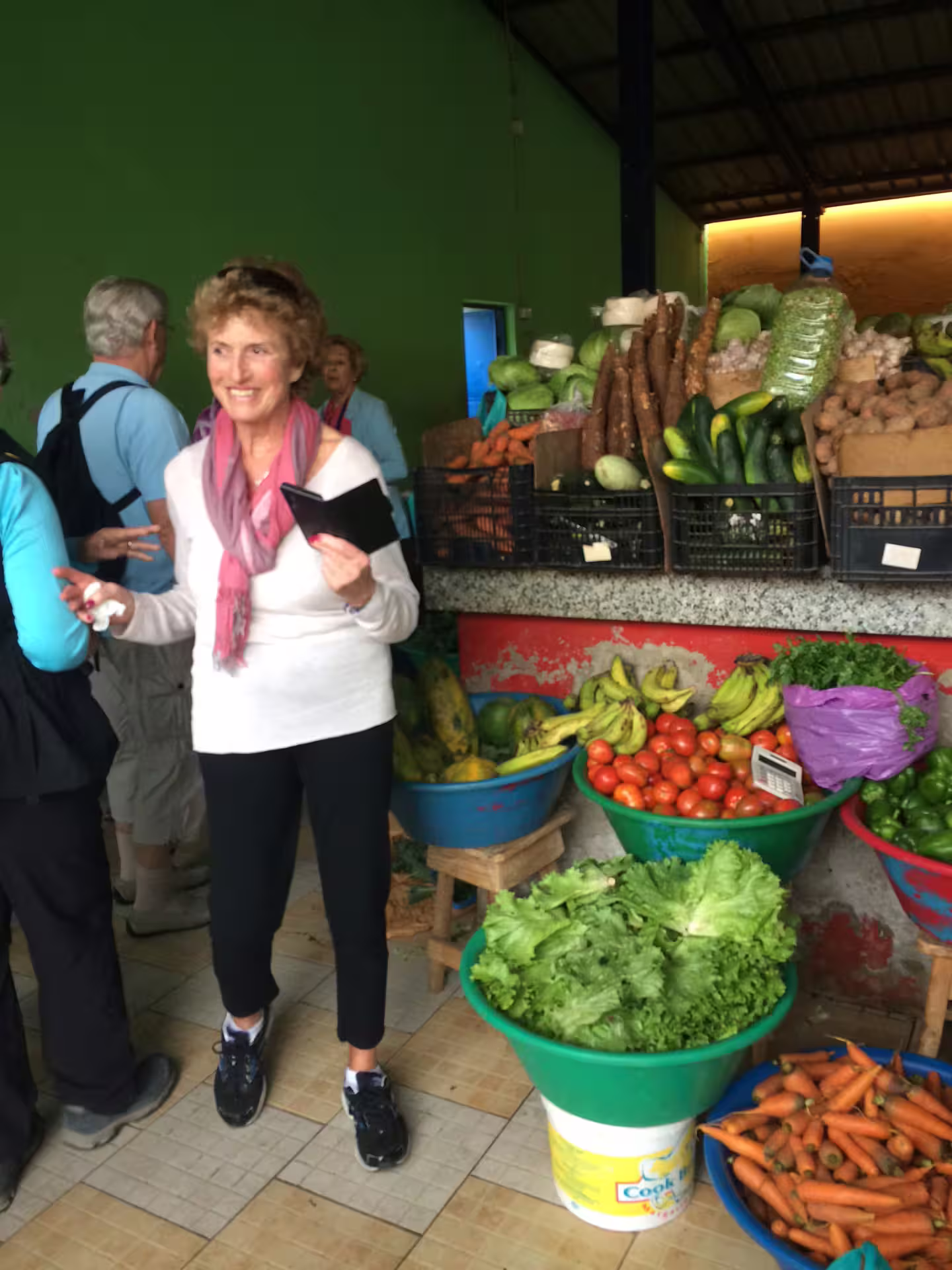 Tourists explore a vibrant local market with fresh produce in Mindelo, São Vicente, highlighting Cape Verdean culture.