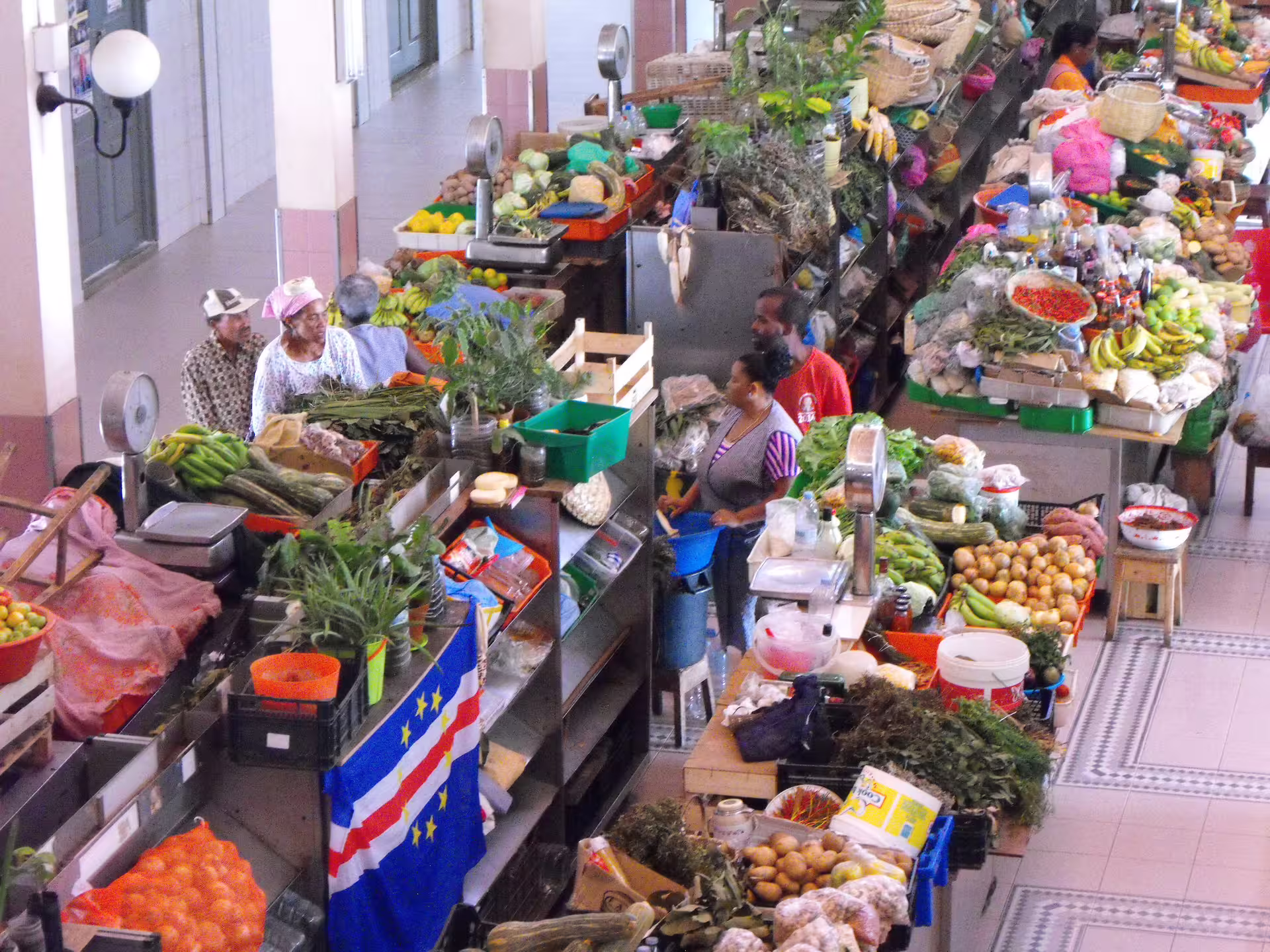 Vibrant Mindelo market scene with locals and fresh produce, showcasing São Vicente's rich culture on a half-day shore excursion.