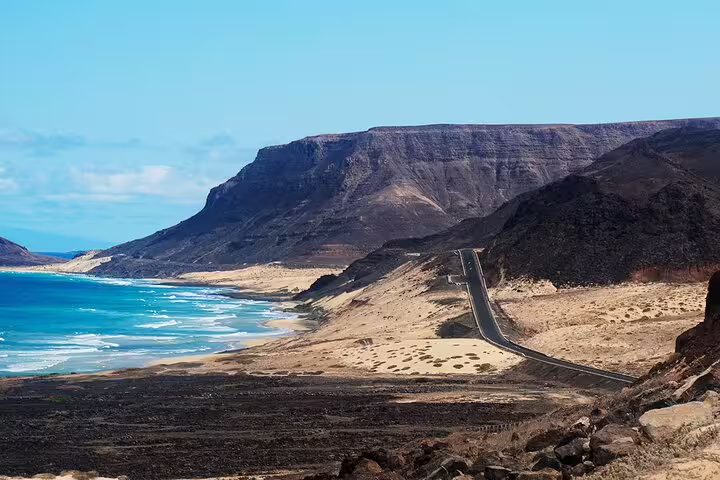 Scenic coastal road with dramatic cliffs and turquoise waters, highlighting the breathtaking views on the Mindelo Port tour.
