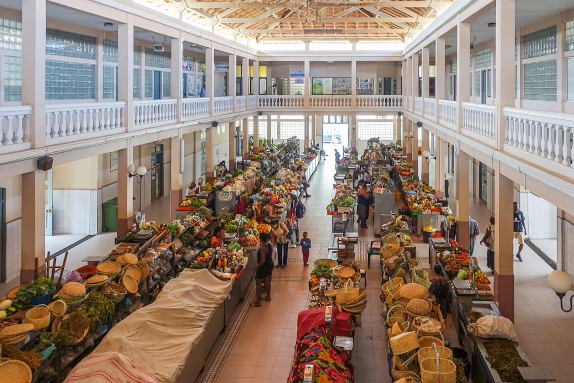Vibrant indoor market scene in Mindelo, São Vicente, showcasing colorful produce and local vendors, ideal for cultural tours.