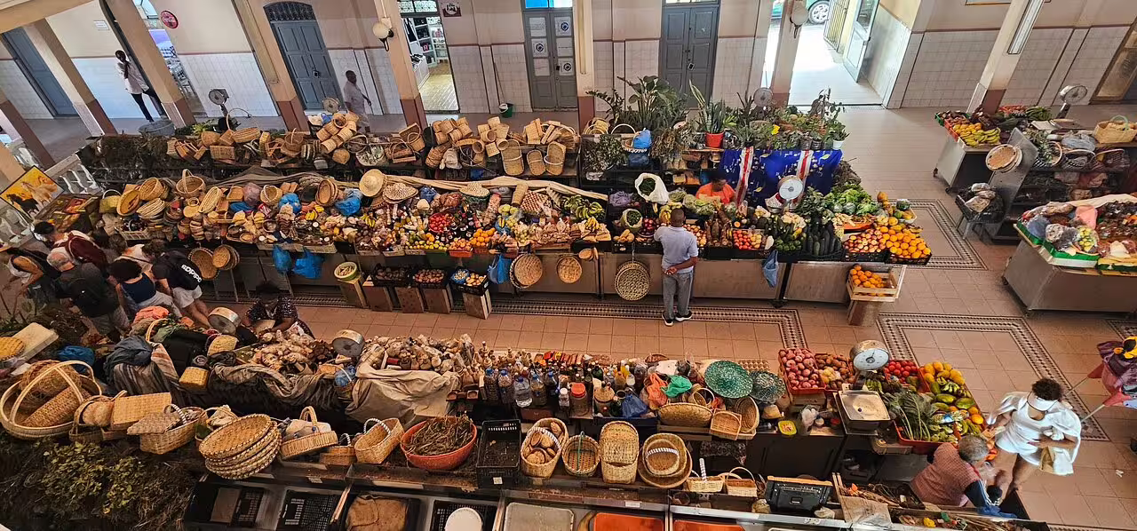 Vibrant market scene in Mindelo, São Vicente, showcasing local produce and baskets, perfect for a full-day shore excursion.