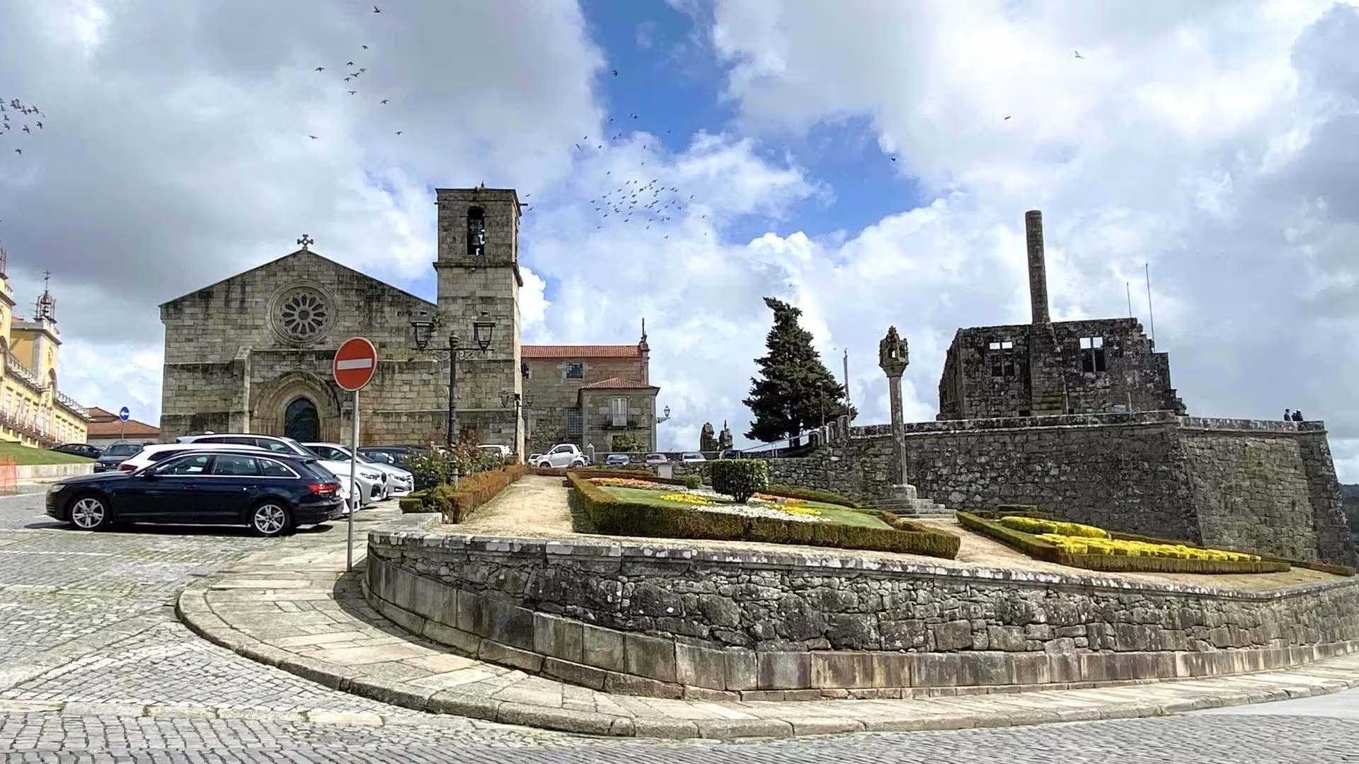 Medieval church and fortress with lush gardens in the picturesque Minho region, Portugal.