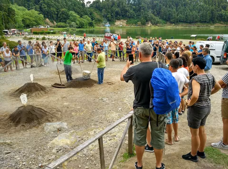 Visitors watch traditional Cozido cooking in Furnas volcanic soil on São Miguel full-day Lake Tour by minibus