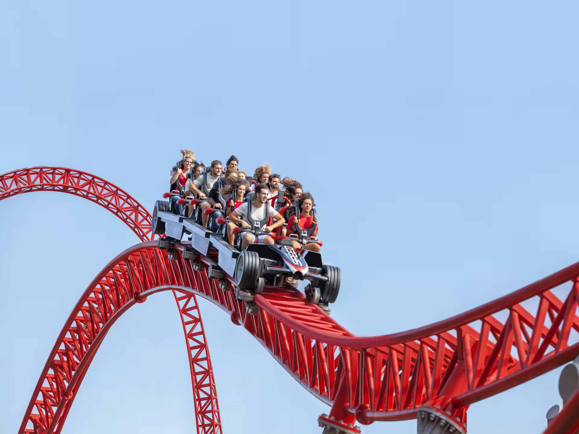 Riders on Mirabilandia’s red roller coaster, part of entry ticket plus Maranello Ferrari Museum visit