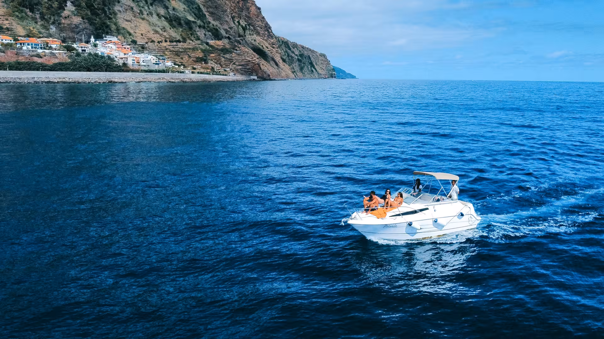 Miranda yacht sailing along a scenic coastline, perfect for whale and dolphin watching tours.