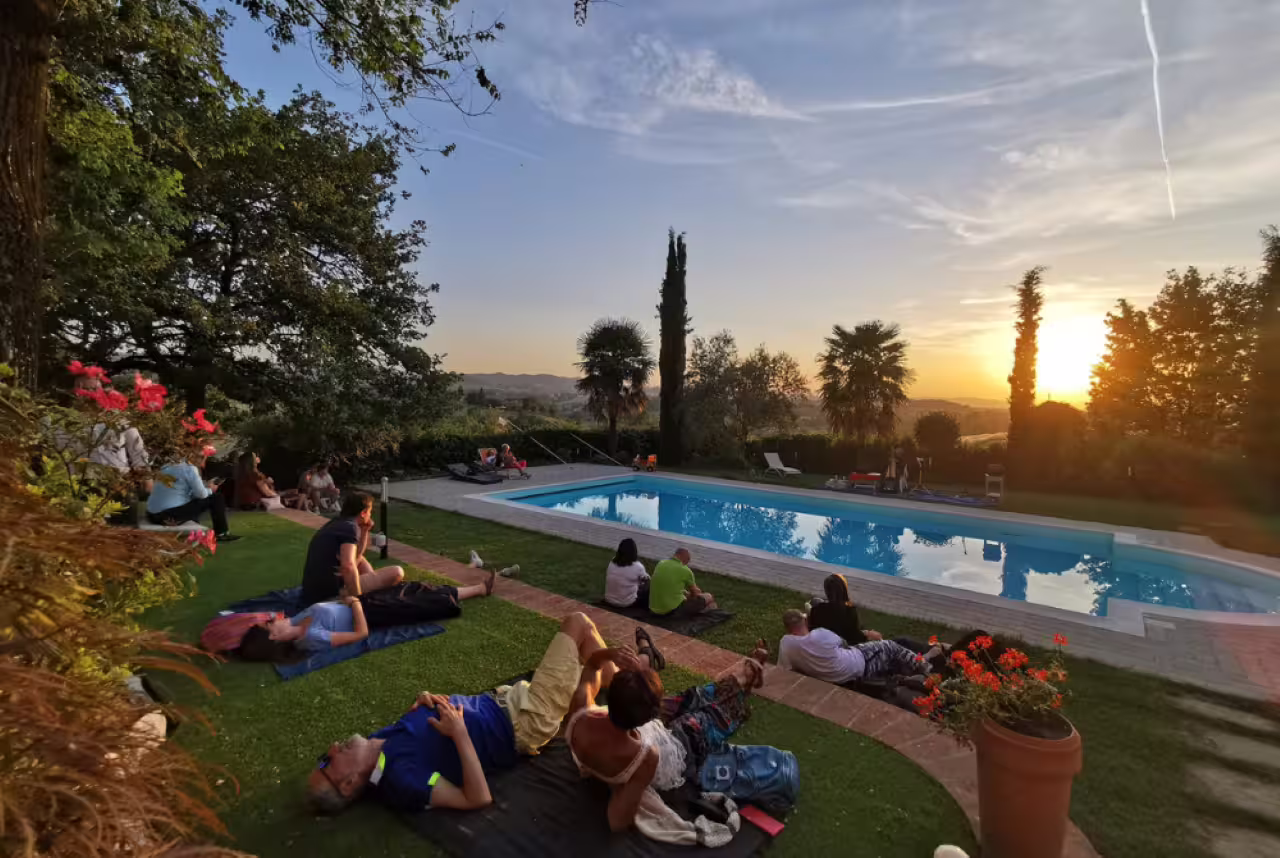 Guests relax by a pool at sunset after Modena balsamic vinegar cellar tour, tasting and Italian aperitif