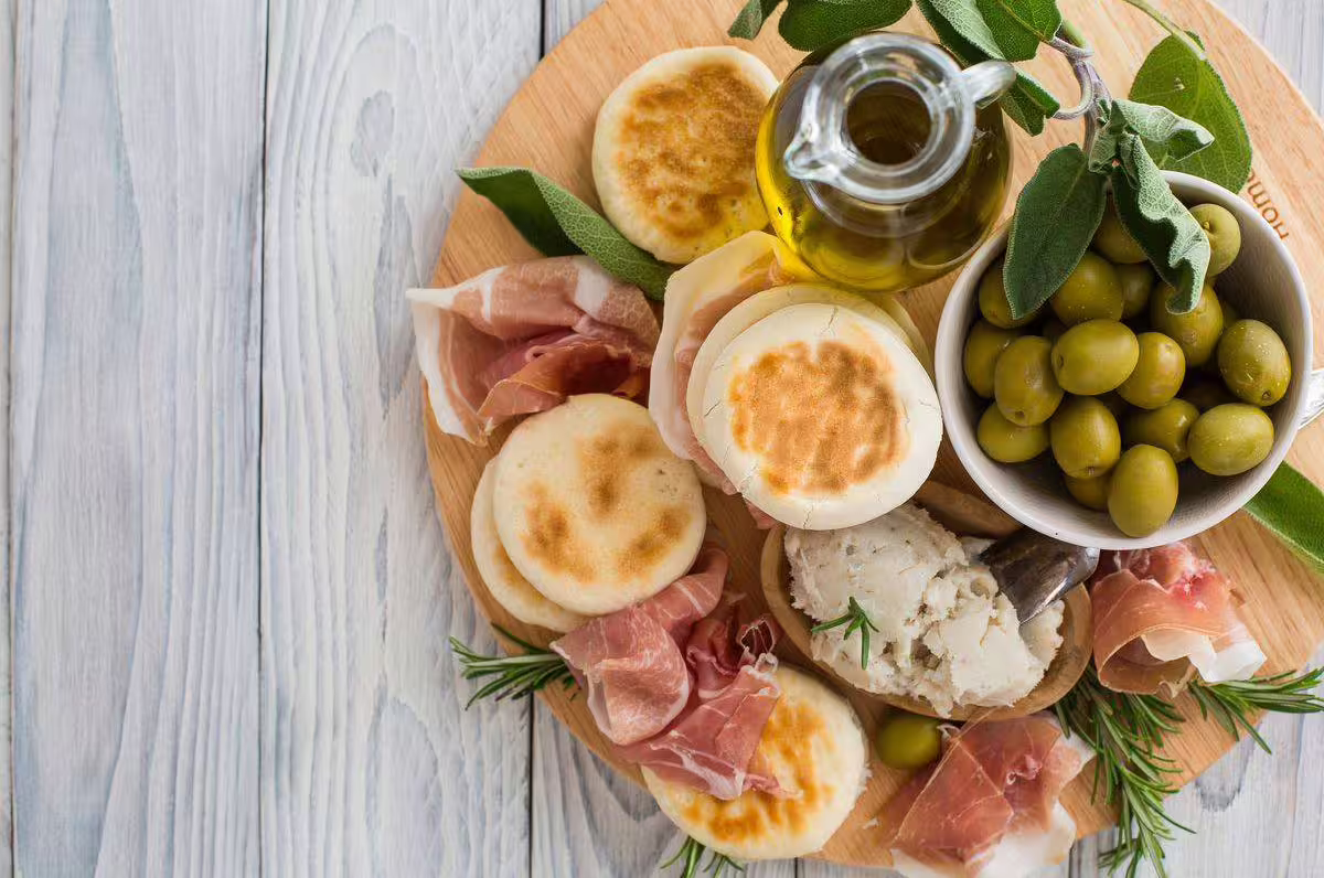 Typical Modena lunch platter with prosciutto, olives, cheese and bread, ideal with balsamic tasting