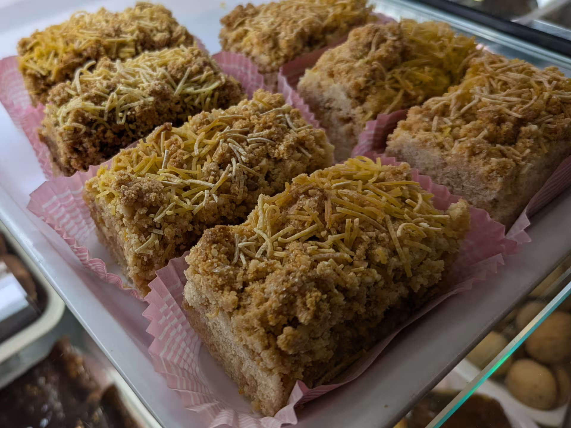 Delicious Italian pastries topped with crumbs and cheese on display during Modena Food Tour, highlighting local flavors.