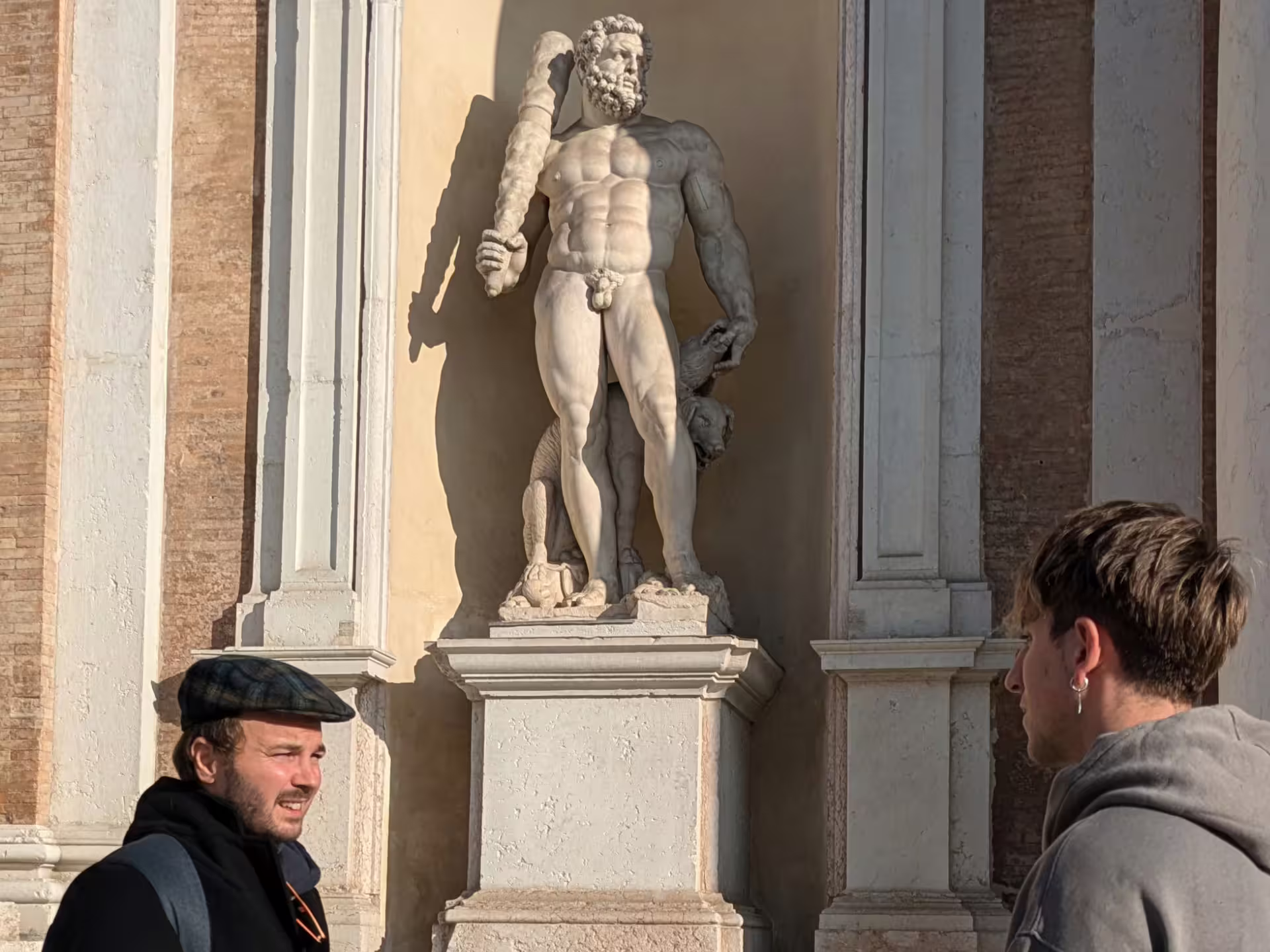 Tourists admire a marble statue in Modena, blending art and culture on the sightseeing and taste tour.