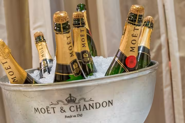 Multiple Moët & Chandon champagne bottles chilling on ice in a branded silver bucket