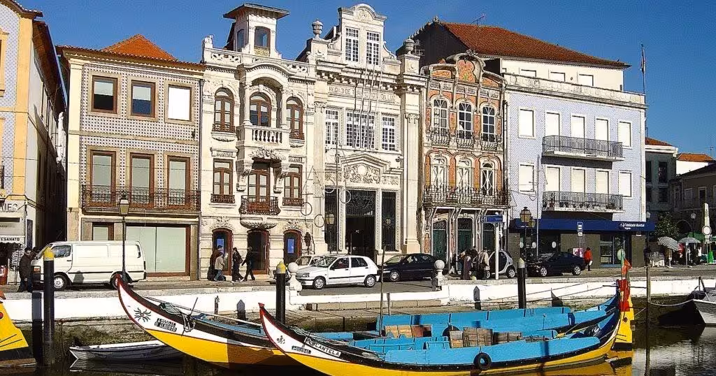 Moliceiro boat on Aveiro canal by Art Nouveau buildings, featured on a private half-day tour to Costa Nova