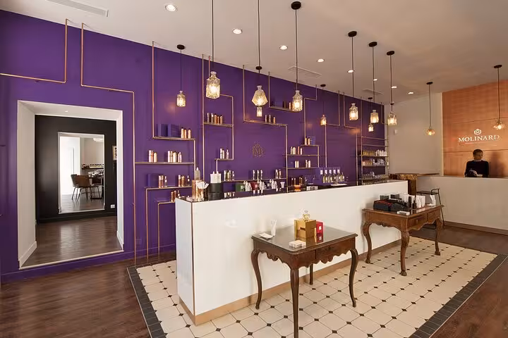 Elegant Molinard perfume boutique with purple walls and gold shelving on the French Riviera
