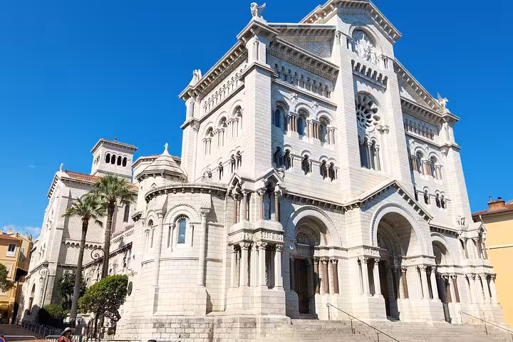 Stunning view of the Monaco Cathedral under a clear blue sky, showcasing its Romanesque-Byzantine architecture.