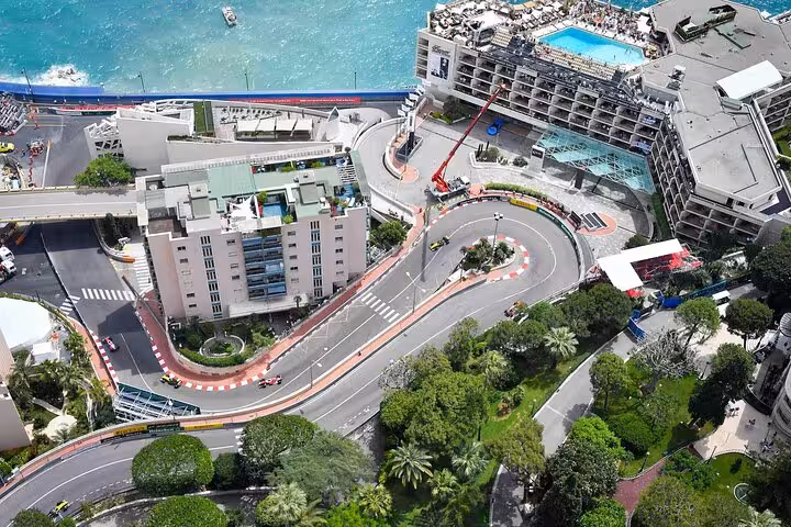 Aerial view of Monaco Grand Prix circuit with hairpin turn, Mediterranean Sea, and luxury hotels