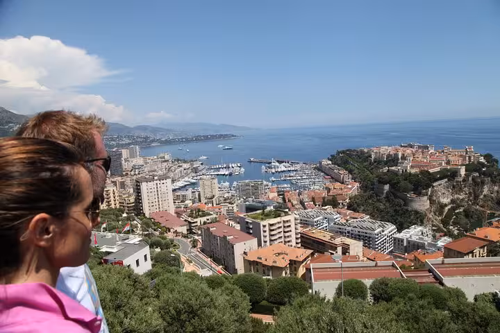 Couple overlooking Monaco harbor and French Riviera coastline on a sunny day