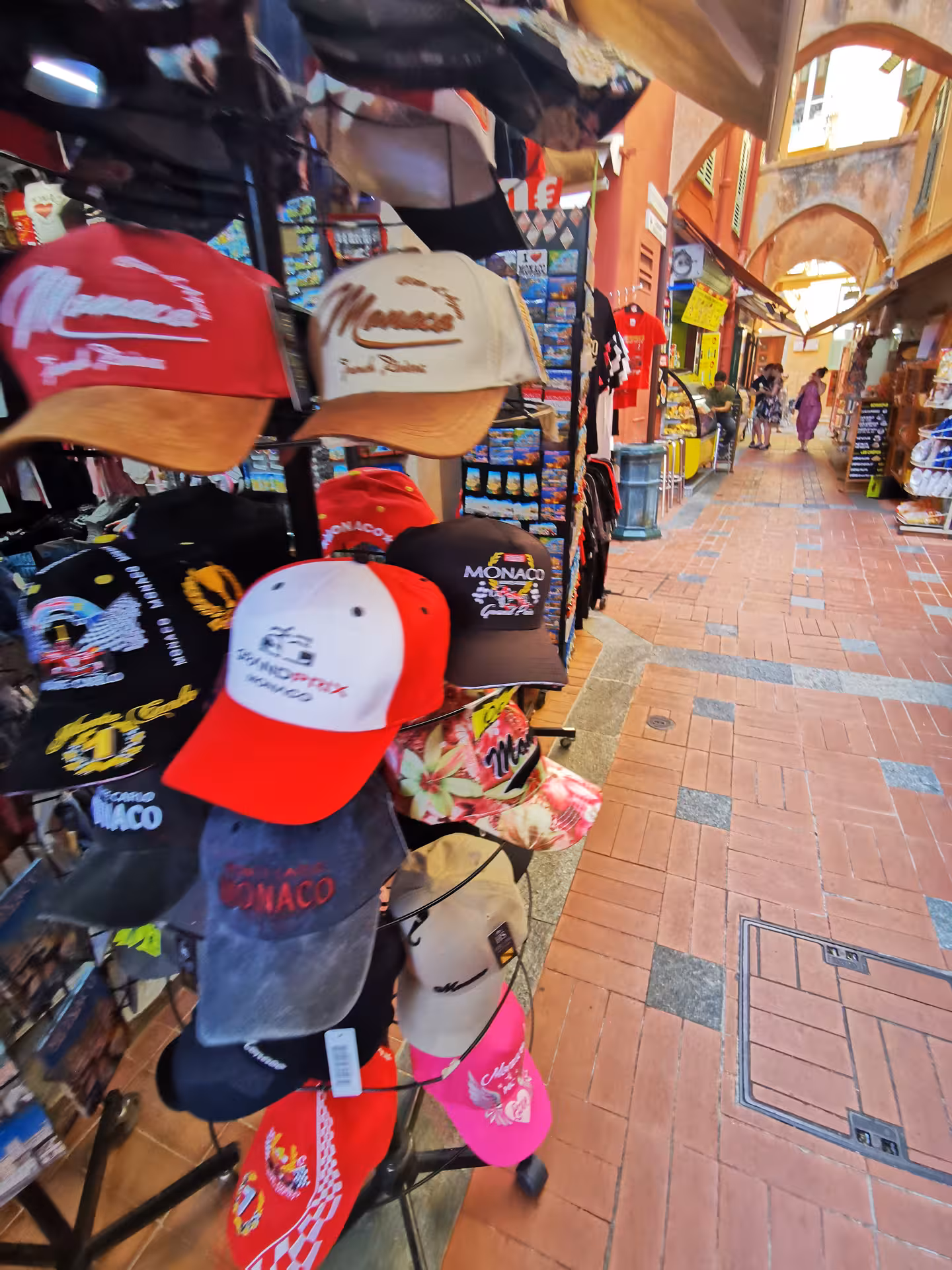 Souvenir caps and postcards in Monaco market arcade on a private Marseille shore excursion day trip to Nice, Eze and Monaco