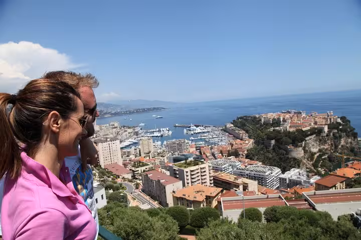 Couple enjoying panoramic view of Monaco harbor and Monte Carlo coastline from scenic overlook