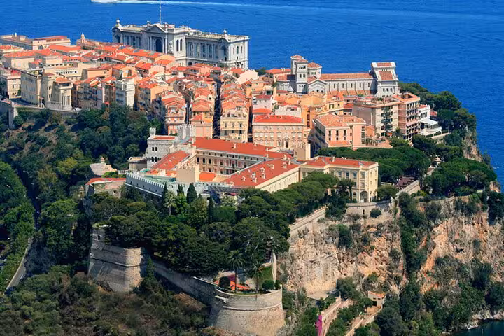 Aerial view of Monaco's historic old town perched on cliffs above the Mediterranean Sea with terracotta rooftops