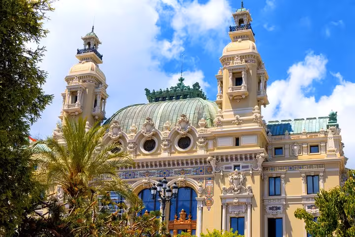 Ornate Belle Époque facade of Monaco's Opera de Monte-Carlo with green copper dome and decorative towers
