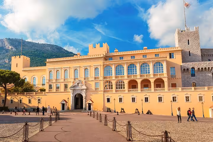 Prince's Palace of Monaco with ornate facade, arched windows, and battlements under blue sky