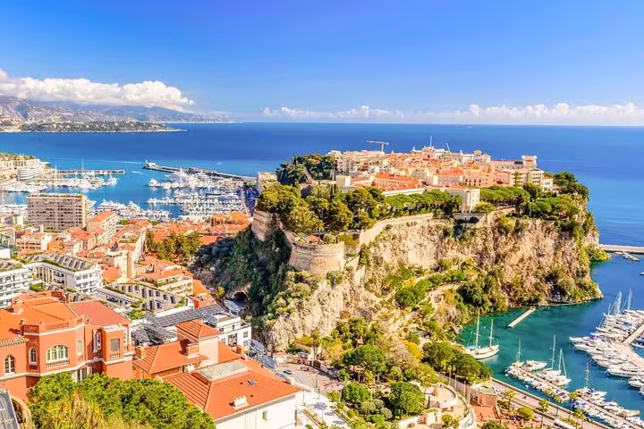 Aerial view of Monaco's Rock with Prince's Palace, luxury yacht harbor, and Mediterranean Sea coastline