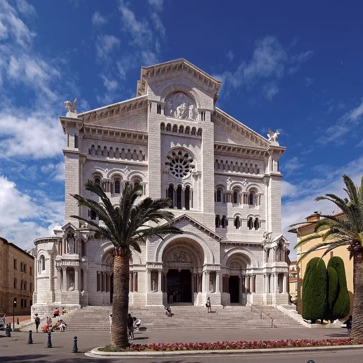 Saint Nicholas Cathedral Monaco white stone facade with rose window and palm trees