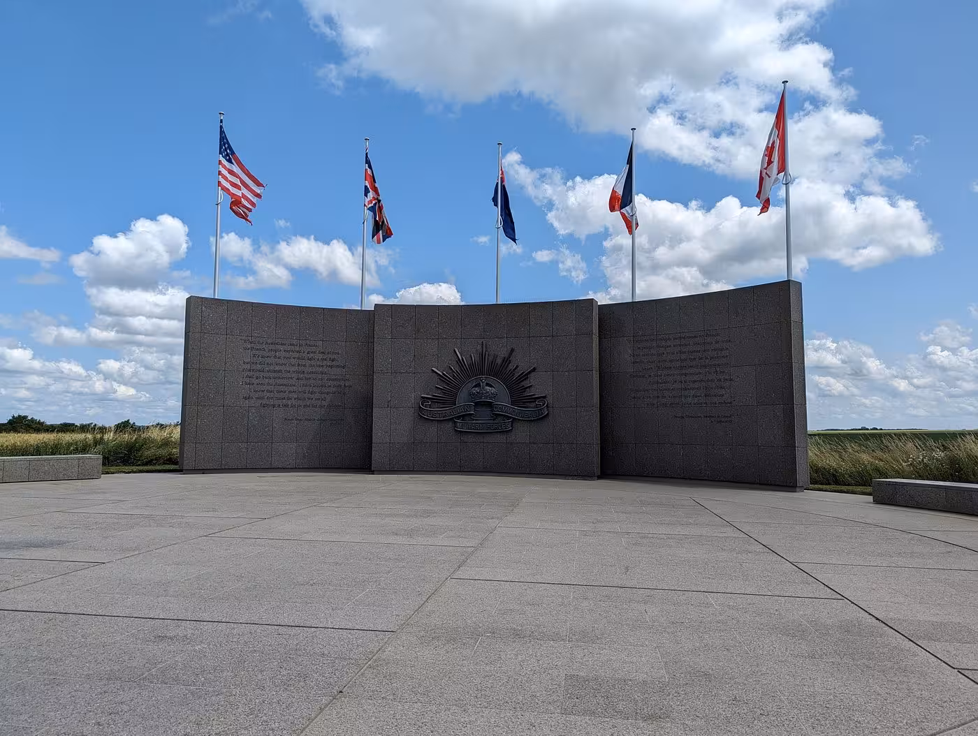 Australian Military Forces memorial wall with five flags at Somme Battlefields, France