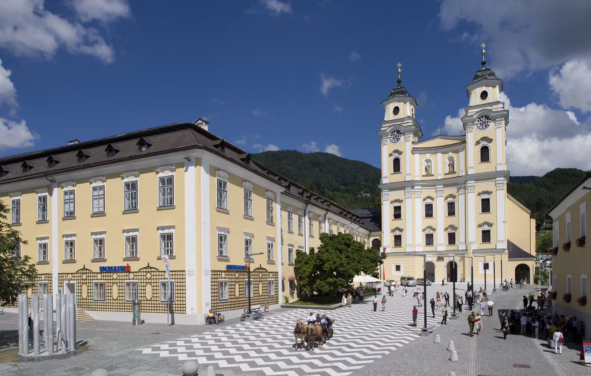 Picturesque Mondsee Basilica and square, iconic Sound of Music location in Austria, popular tourist attraction.