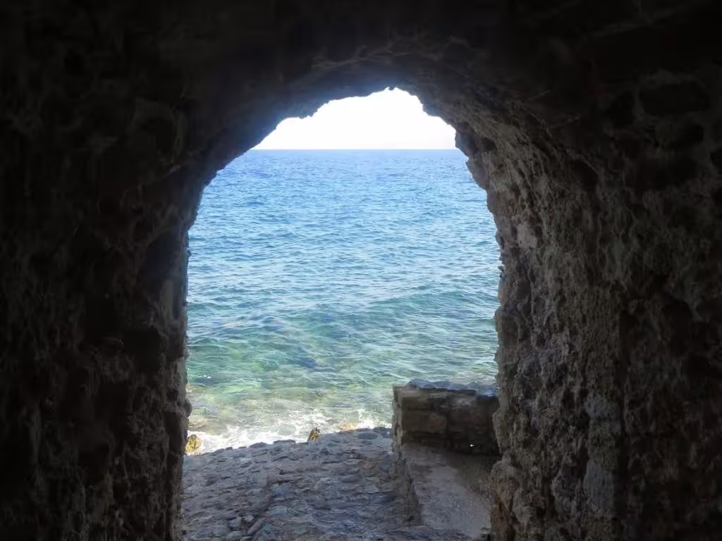 Sea view through a stone archway in Monemvasia fortress, highlight of the 2-day private Sparta Mystras tour overnight