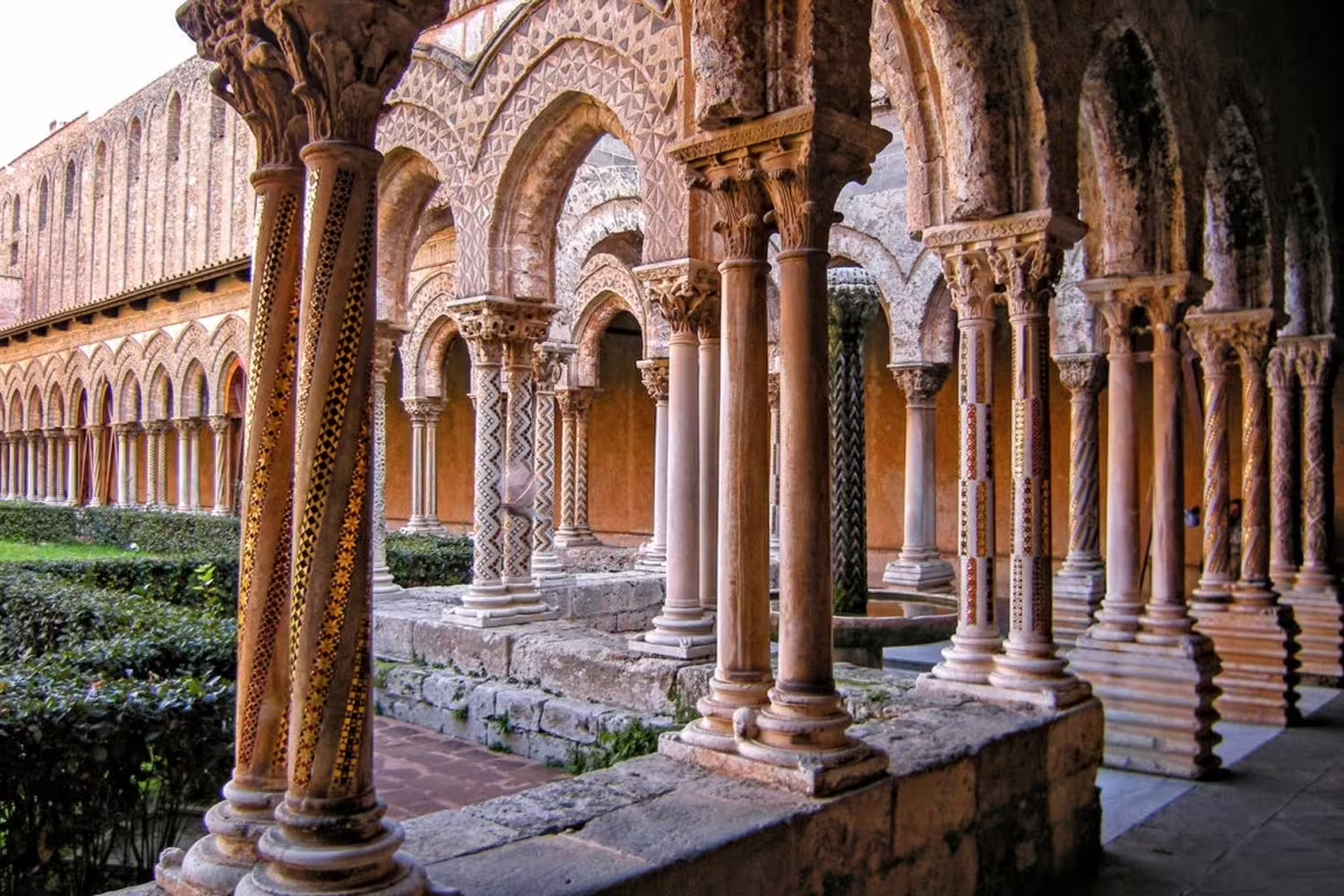 Intricate Norman-Arab cloister columns and arches of Monreale Cathedral near Palermo, visited on a private guided tour