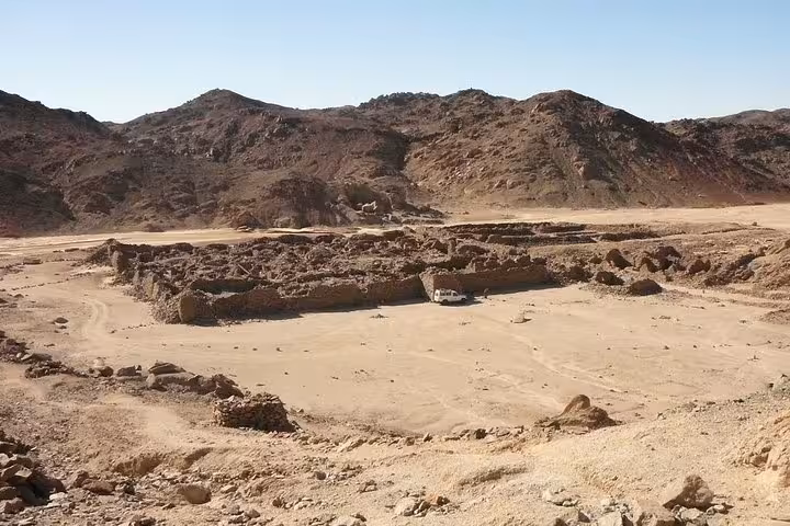 Wide view of Mons Claudianus quarry ruins and desert hills near Safaga, Egypt, on a guided jeep safari