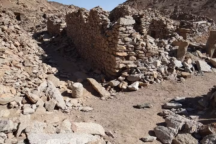 Collapsed stone walls and sandy path at Mons Claudianus ruins, visited on a Safaga Egypt Jeep safari tour