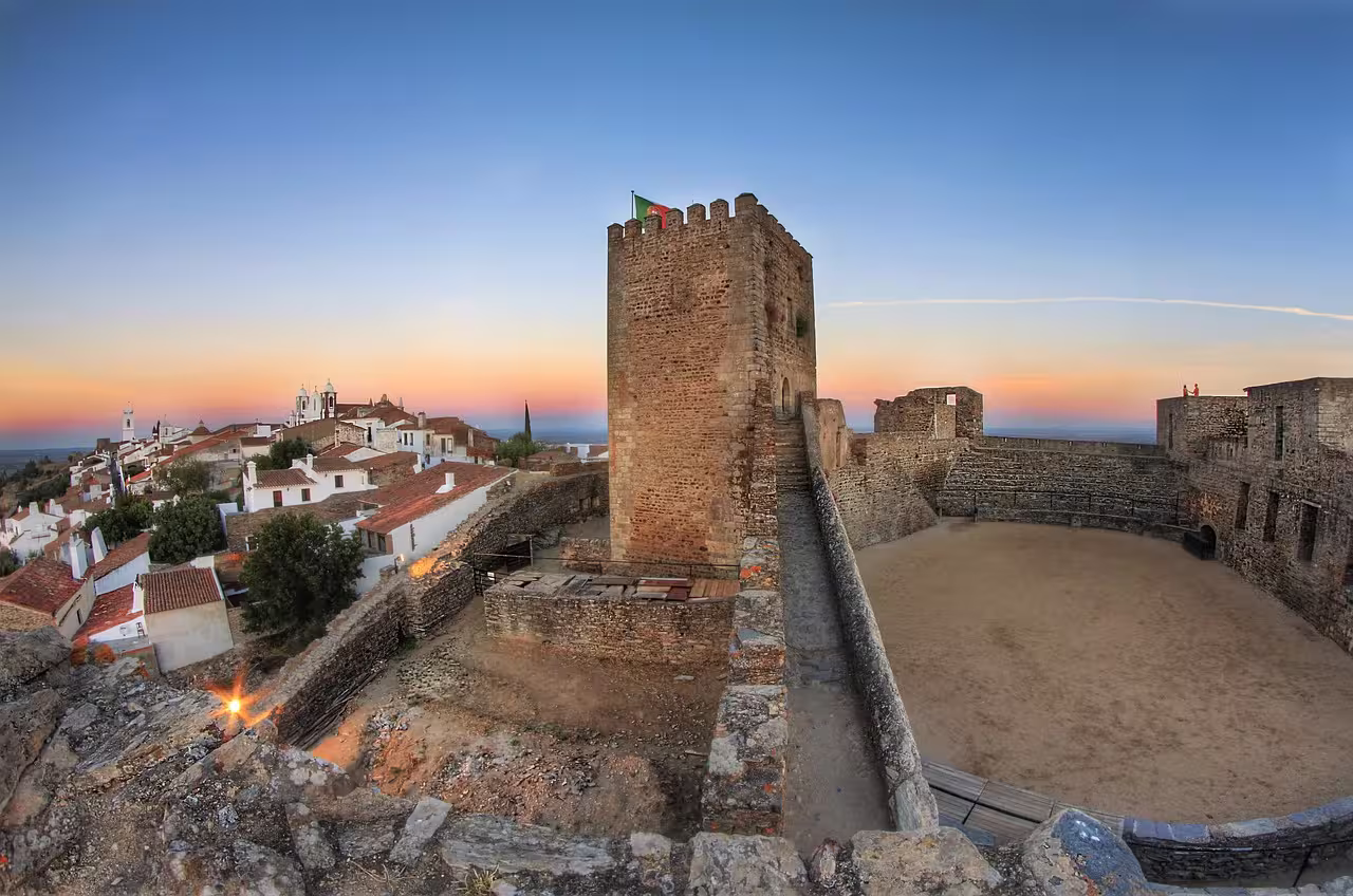 Monsaraz Castle panoramic view at sunset, showcasing historic architecture and scenic Alentejo landscapes.