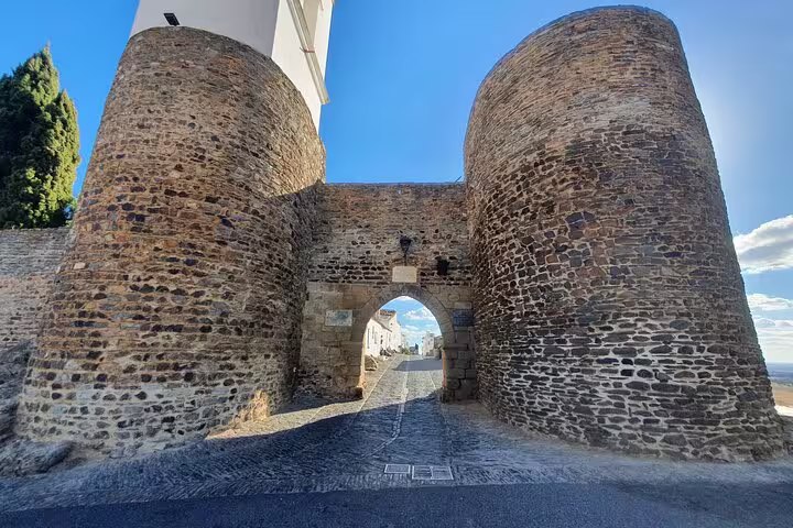 Ancient stone gateway in Monsaraz, Portugal, showcasing medieval architecture on the Évora & Monsaraz small-group tour.