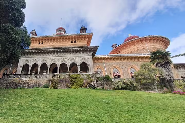Monserrate Palace in Sintra, Portugal, highlighting its intricate design and lush green gardens.
