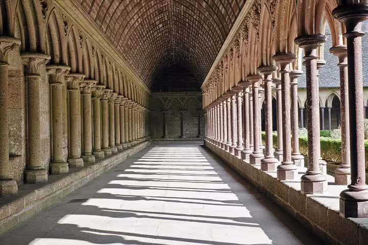Gothic vaulted corridor with ornate columns in Mont Saint-Michel Abbey cloister