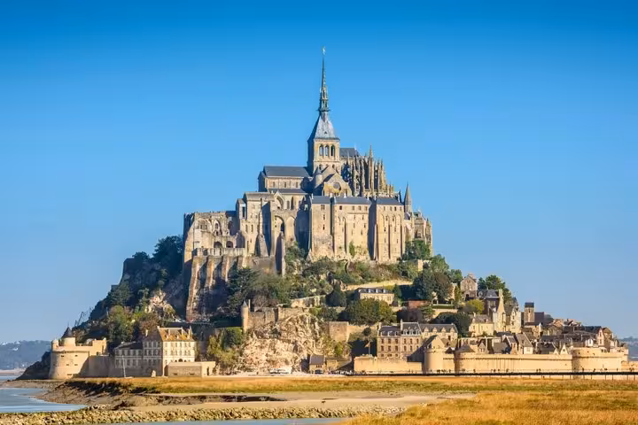 Mont-Saint-Michel abbey rising on a rocky island above tidal flats in Normandy, France