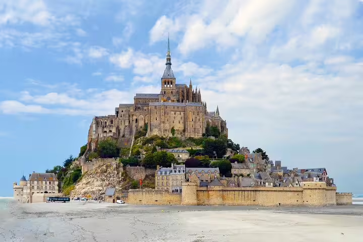 Mont Saint Michel island abbey rising above tidal flats in Normandy, France